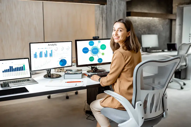 Financial Analyst looking at computer screen analyzing data